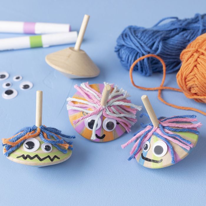 Trottole con occhi finti e capelli allegri