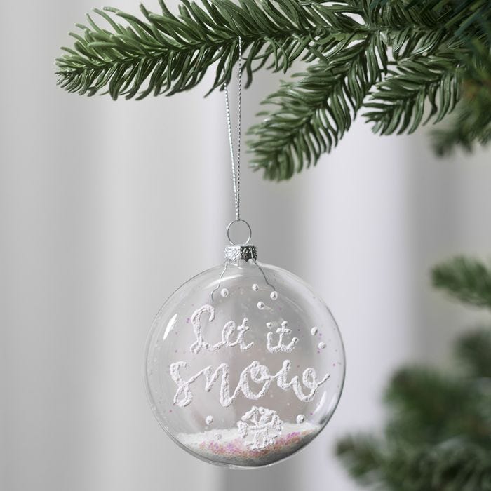 A flat glass bauble decorated with 3D Snow Effect