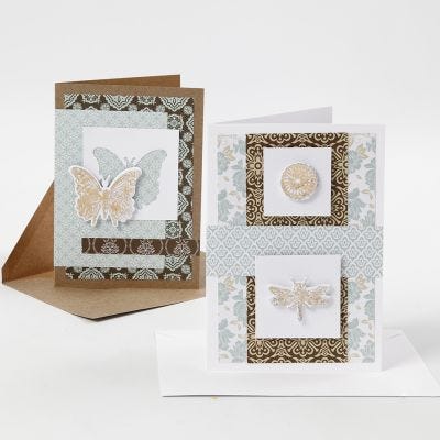 Biglietti d'auguri decorati con carta fantasia e disegni fustellati con pellicola decorativa