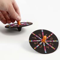 A painted Spinning Top decorated with Markers and Sequins