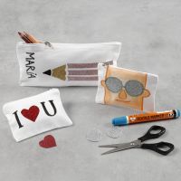 Un astuccio per le matite e un borsellino decorati con pellicola stirabile e pennarelli per stoffa