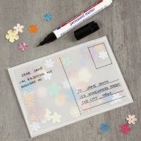A post card made from vellum paper and filled with sequins